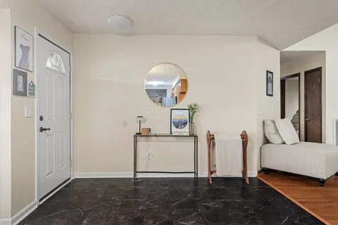 a view of a livingroom with furniture and a hallway