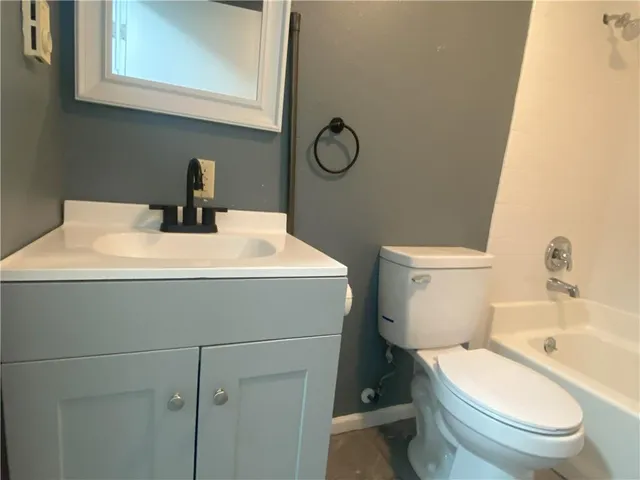 a view of an empty room with window and cabinet