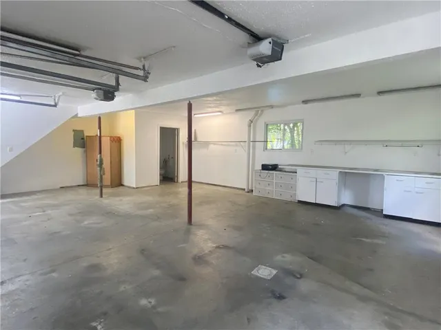 a kitchen with stainless steel appliances granite countertop a sink stove and white cabinets