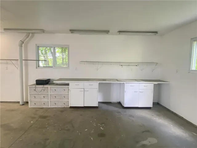 a kitchen with granite countertop white cabinets and white appliances