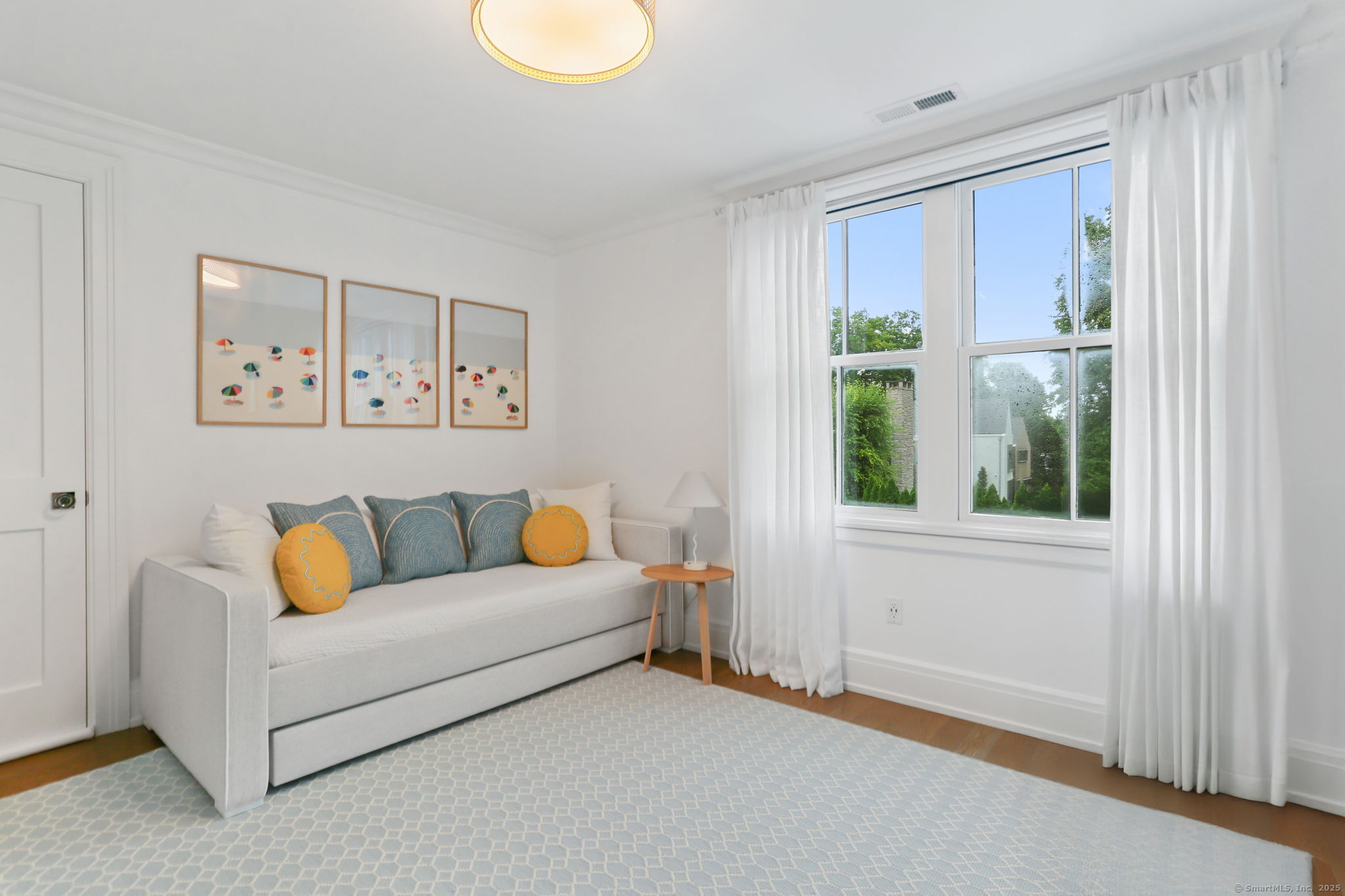 28 Norwalk Avenue Westport, CT 06880 - Photo 26 of 36 a white couch sitting in a living room next to a window