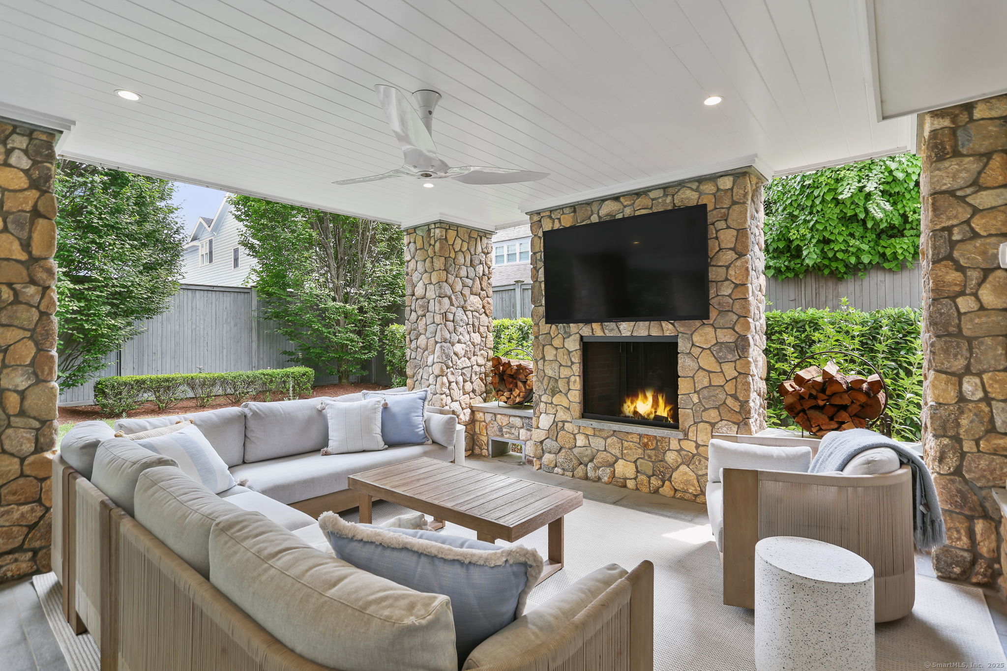 28 Norwalk Avenue Westport, CT 06880 - Photo 32 of 36 a living room with furniture a flat screen tv and a fireplace