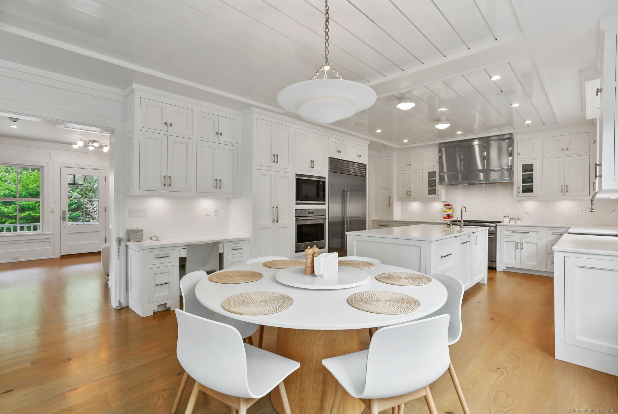 28 Norwalk Avenue Westport, CT 06880 - Photo 9 of 36 a kitchen with a dining table chairs and refrigerator