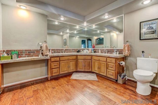 a kitchen with a sink cabinets and wooden floor