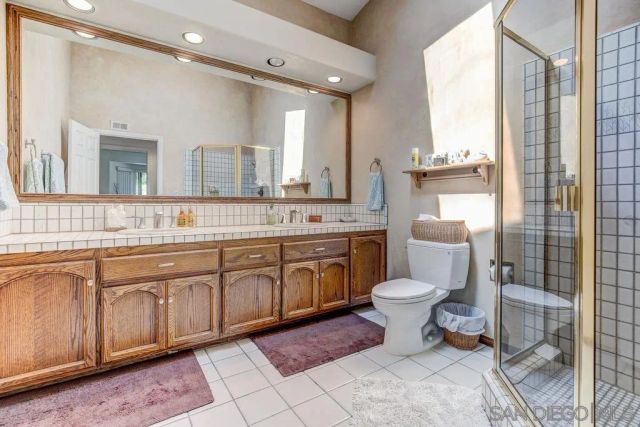 a spacious bathroom with a toilet sink and mirror