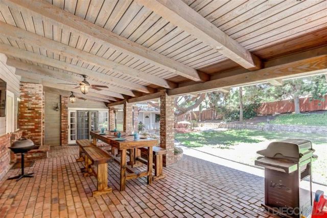 a dining room with furniture wooden floor and a garden view