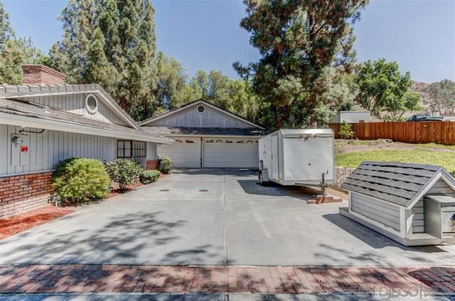 a view of a house with a yard and a garage