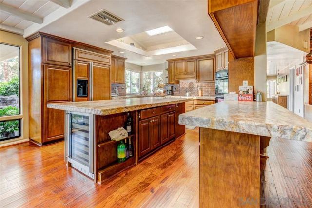a kitchen with stainless steel appliances granite countertop sink stove and wooden floor