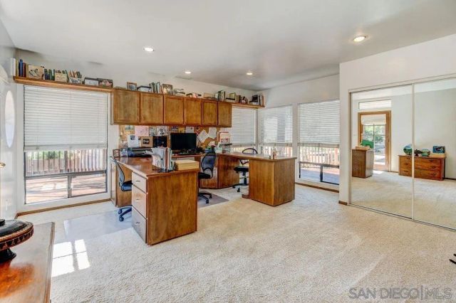 a living room with stainless steel appliances furniture cabinets and a wooden floor