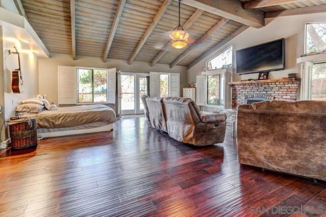 a living room with fireplace furniture and a flat screen tv
