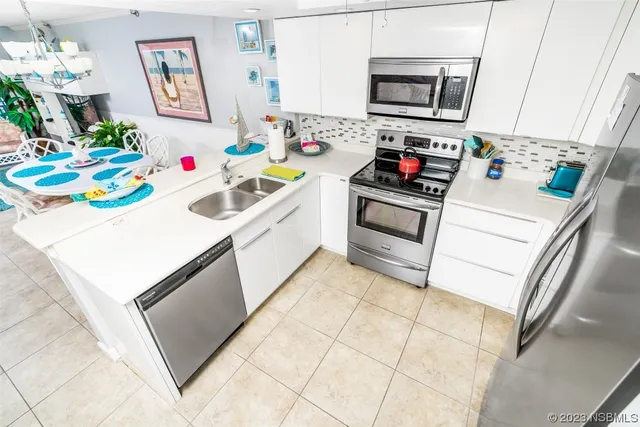 a kitchen with a sink a stove and microwave