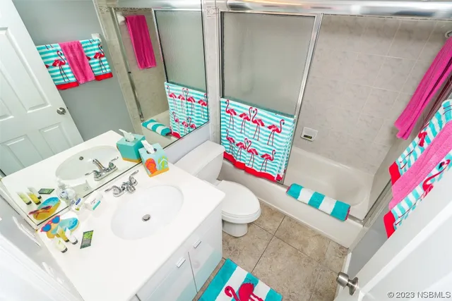 a utility room with sink and mirror