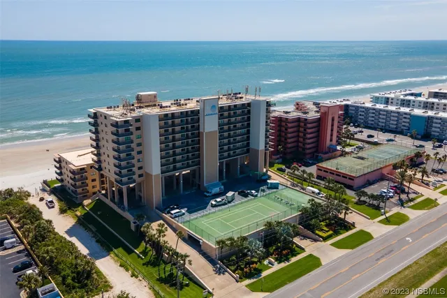 a view of pool with outdoor seating and house in the background