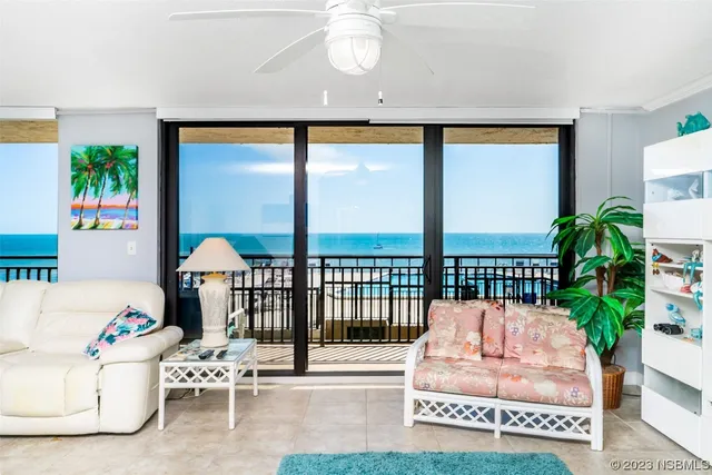 a living room with a large window and a table