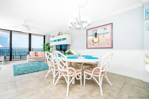 a dining room with furniture a rug and a chandelier