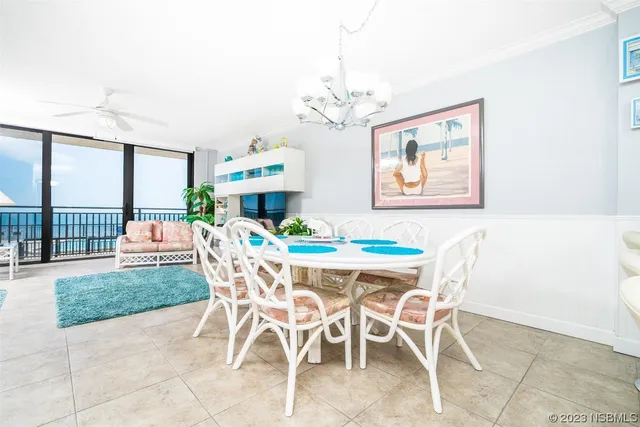 a dining room with furniture a rug and a chandelier