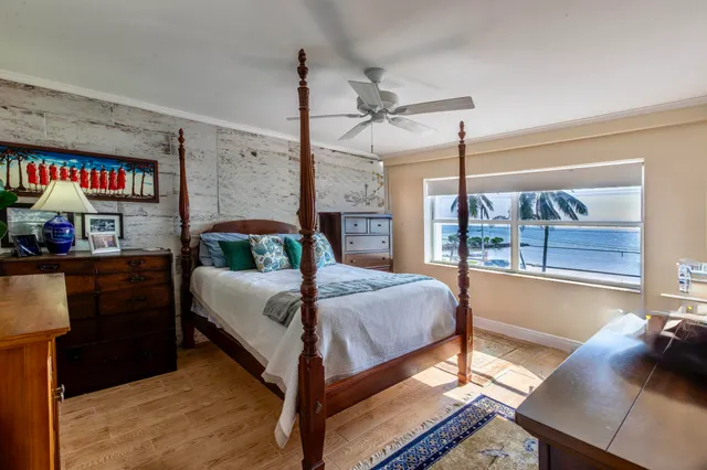 a kitchen with stainless steel appliances granite countertop a stove top oven a sink dishwasher a dining table and chairs with wooden floor