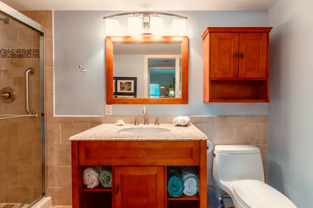 a bathroom with a granite countertop sink double and mirror