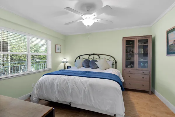 a bedroom with a large bed and a large window