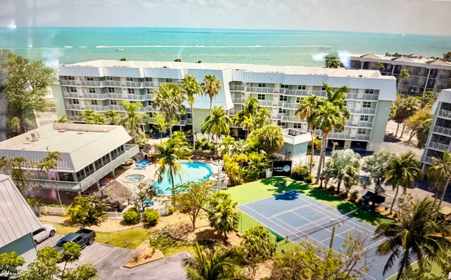 a bathroom with a granite countertop shower a sink and mirror