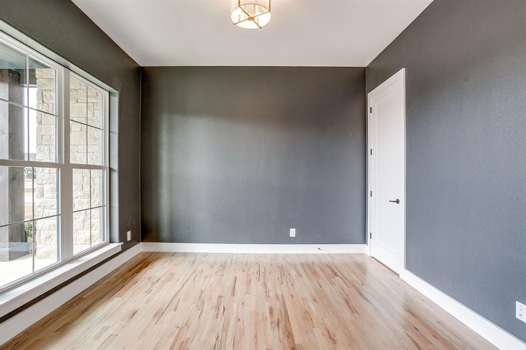 456 Acorn Trail Granbury, TX 76049 - Photo 13 of 40 a view of an empty room with wooden floor and a window