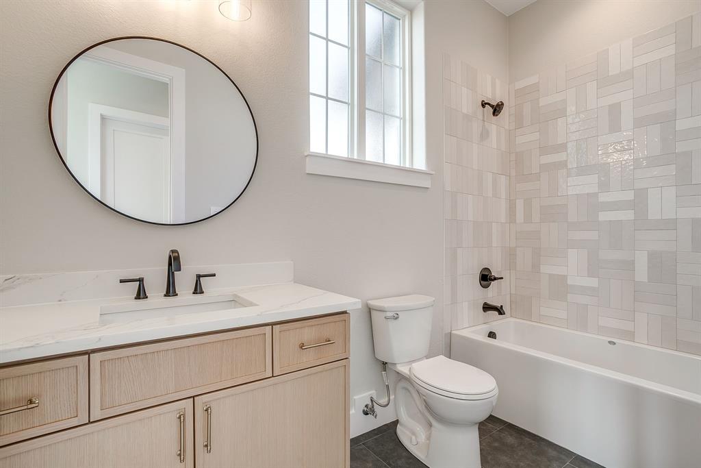 456 Acorn Trail Granbury, TX 76049 - Photo 20 of 40 a bathroom with a sink toilet and a mirror