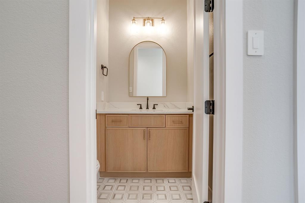 456 Acorn Trail Granbury, TX 76049 - Photo 24 of 40 a bathroom with a sink and a mirror