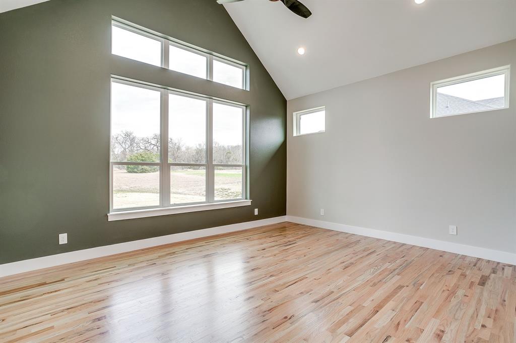 456 Acorn Trail Granbury, TX 76049 - Photo 25 of 40 a view of an empty room with wooden floor and a window