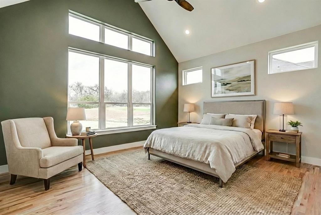 456 Acorn Trail Granbury, TX 76049 - Photo 26 of 40 a bedroom with a large bed couch and a large window