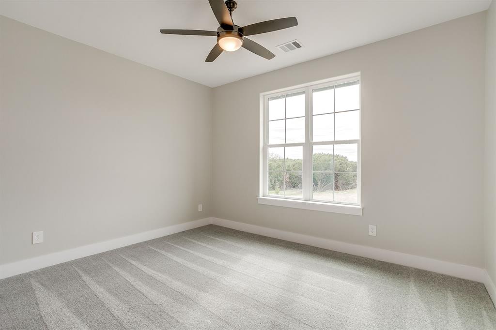 456 Acorn Trail Granbury, TX 76049 - Photo 31 of 40 an empty room with a window and a fan