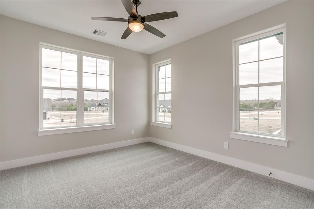 456 Acorn Trail Granbury, TX 76049 - Photo 35 of 40 an empty room with a window and a fan