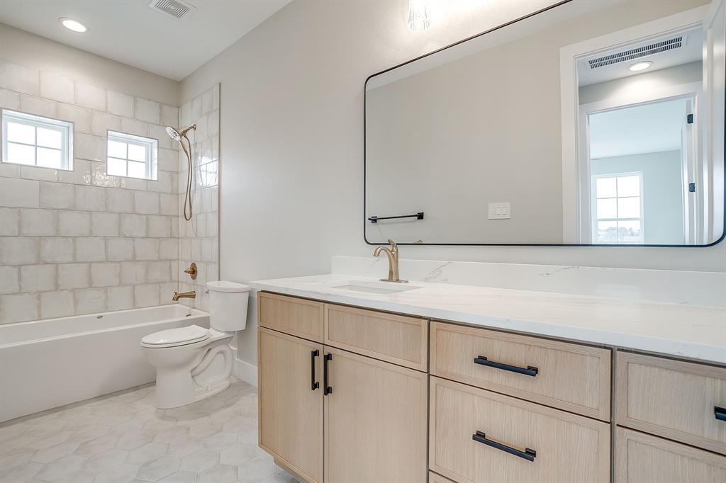 456 Acorn Trail Granbury, TX 76049 - Photo 36 of 40 a bathroom with a double vanity sink toilet and shower