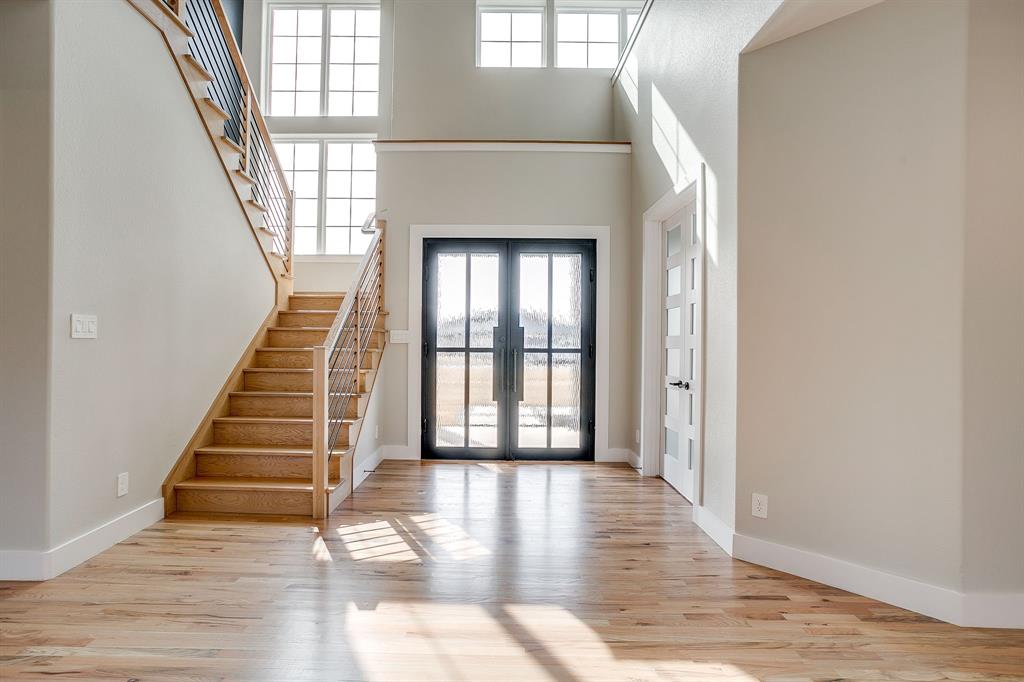 456 Acorn Trail Granbury, TX 76049 - Photo 4 of 40 a view of an entryway with wooden floor and door