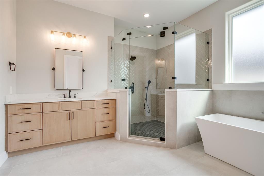 456 Acorn Trail Granbury, TX 76049 - Photo 6 of 40 a spacious bathroom with a double vanity sink a mirror and a shower