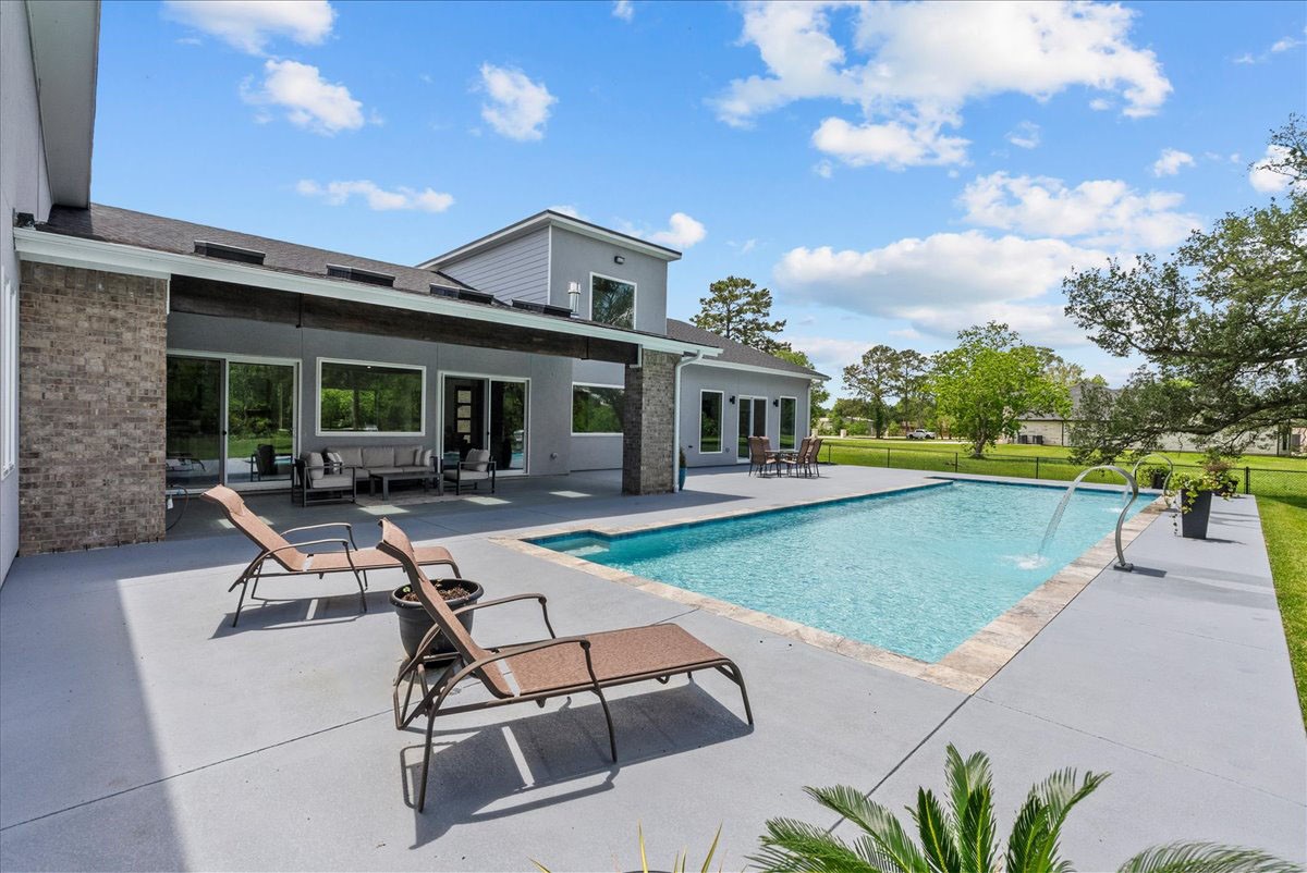 7627 Scott Avenue Manvel, TX 77578 - Photo 43 of 50 The resort-style pool features dual scupper water features.