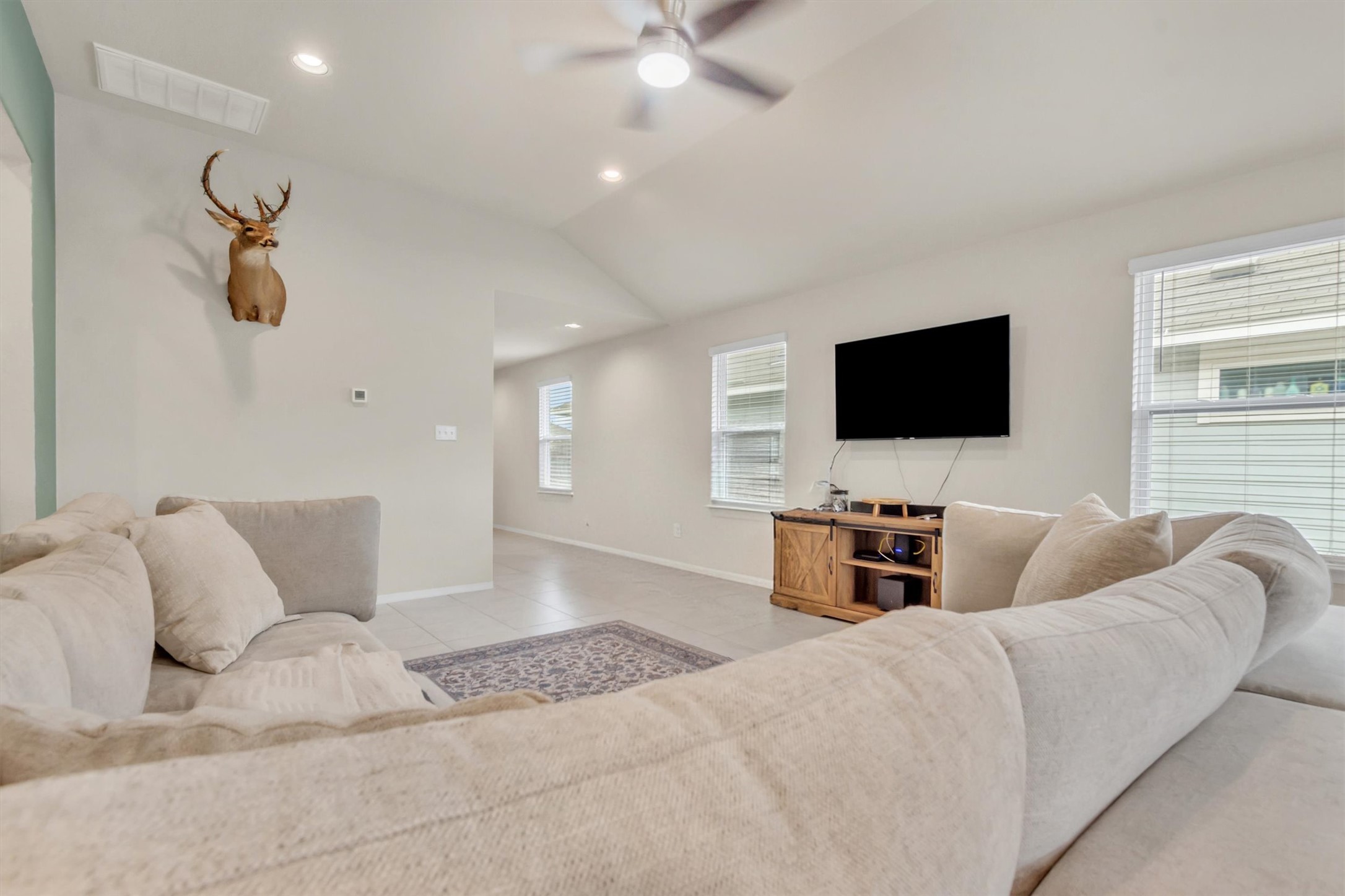 460 Delta Crest Maxwell, TX 78656 - Photo 5 of 18 Tiled living room with a ceiling fan, lofted ceiling, and recessed lighting