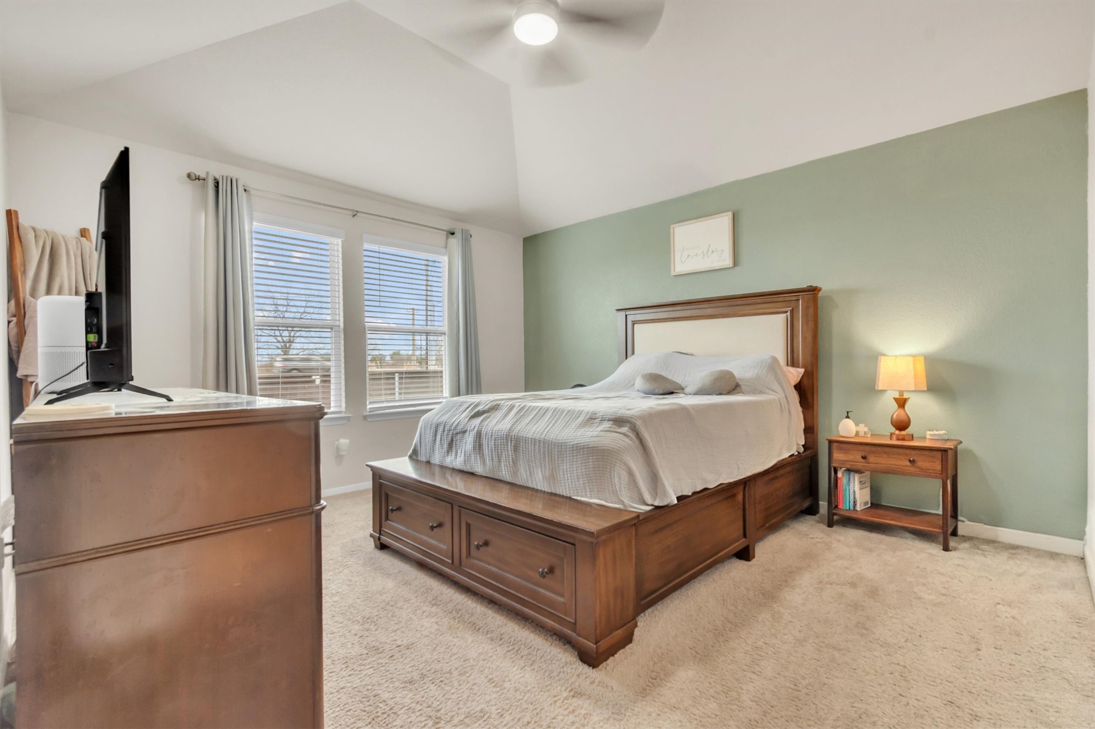 460 Delta Crest Maxwell, TX 78656 - Photo 9 of 18 Bedroom featuring light colored carpet, vaulted ceiling, and ceiling fan
