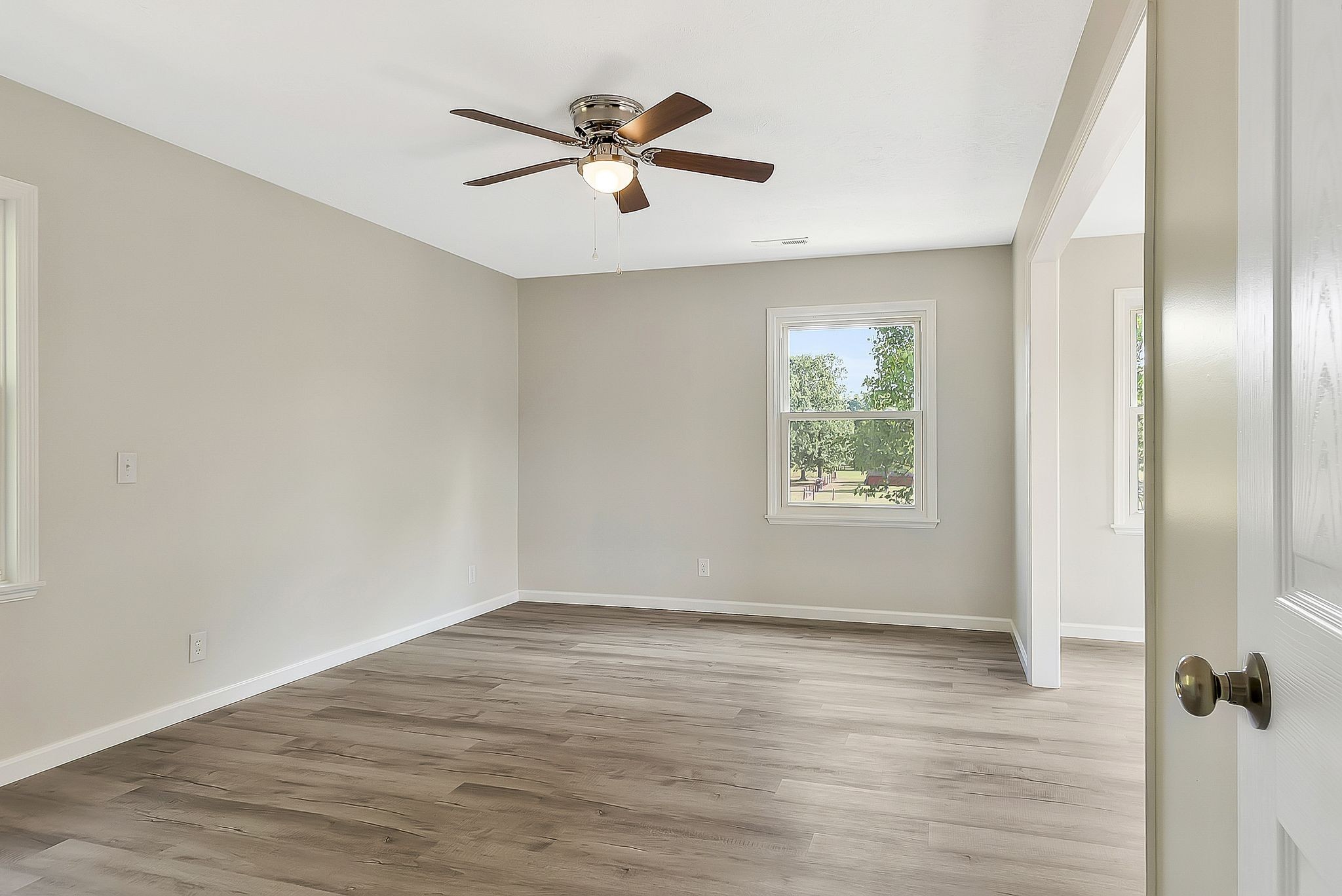3289 Buffalo Road Ethridge, TN 38456 - Photo 23 of 45 an empty room with wooden floor fan and windows
