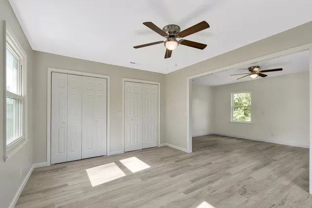 wooden floor in an empty room with a window