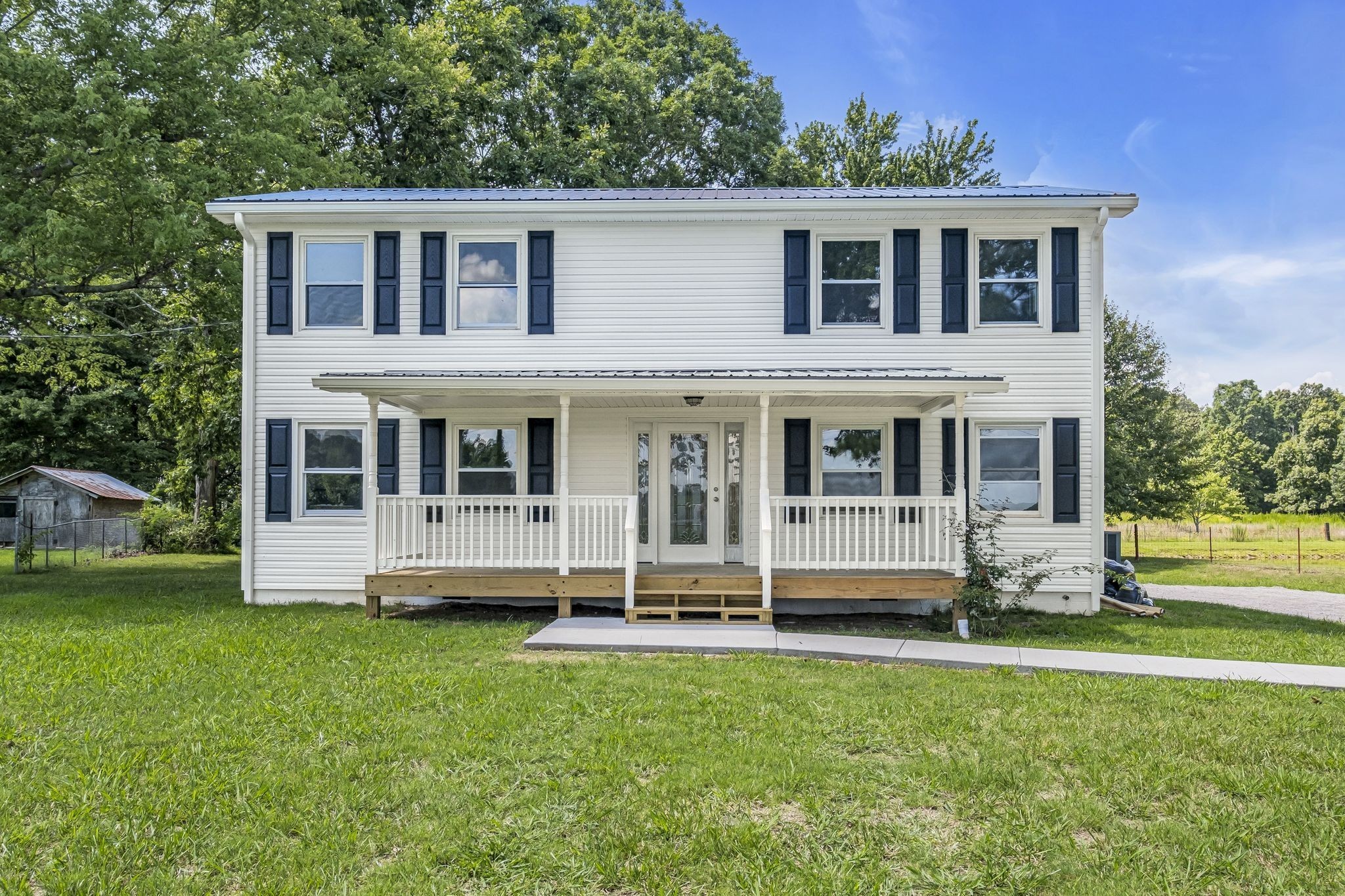 3289 Buffalo Road Ethridge, TN 38456 - Photo 7 of 45 a large house with a big yard and large trees