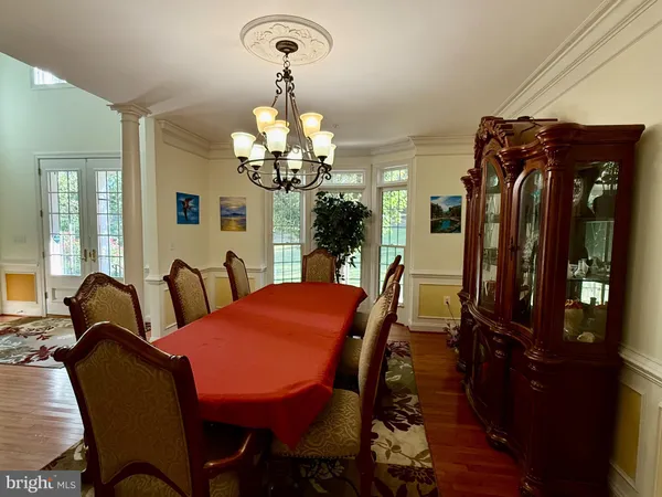 a view of a dining room with furniture and chandelier