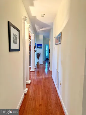a view of a hallway with wooden floor