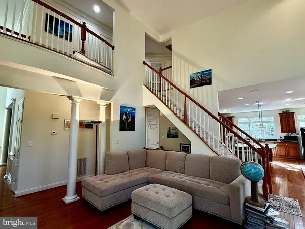 a living room with furniture and stairs