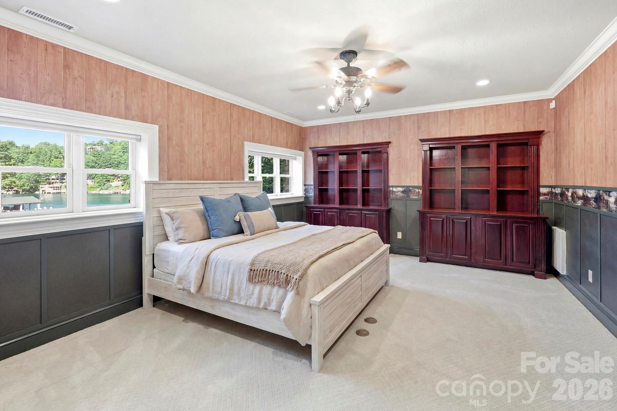 151 Garner Road Lake Lure, NC 28746 - Photo 28 of 48 a spacious bedroom with a large bed and a chandelier