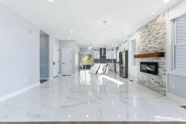a kitchen with granite countertop white cabinets and black appliances