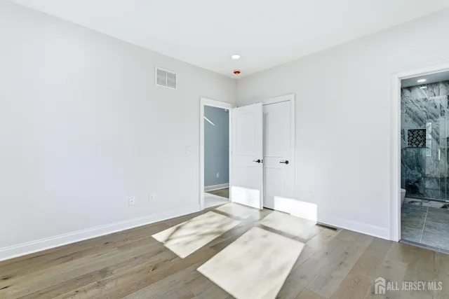 a view of hallway with wooden floor