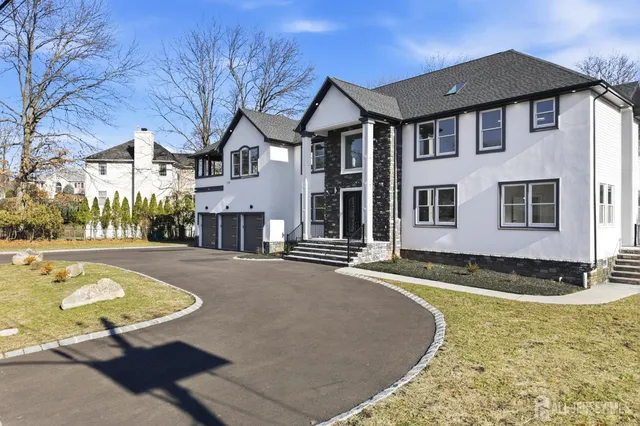 a view of a house with pool and snow on the road