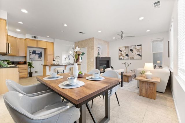 a kitchen with a table and chairs