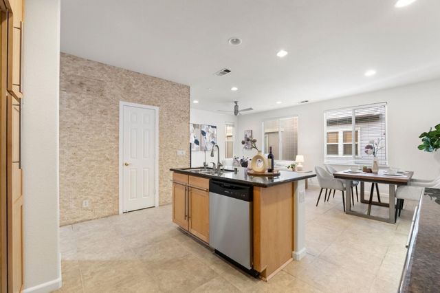 a view of kitchen with kitchen island dining table and chairs