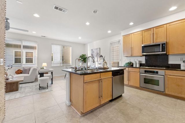 a kitchen with microwave a stove and cabinets